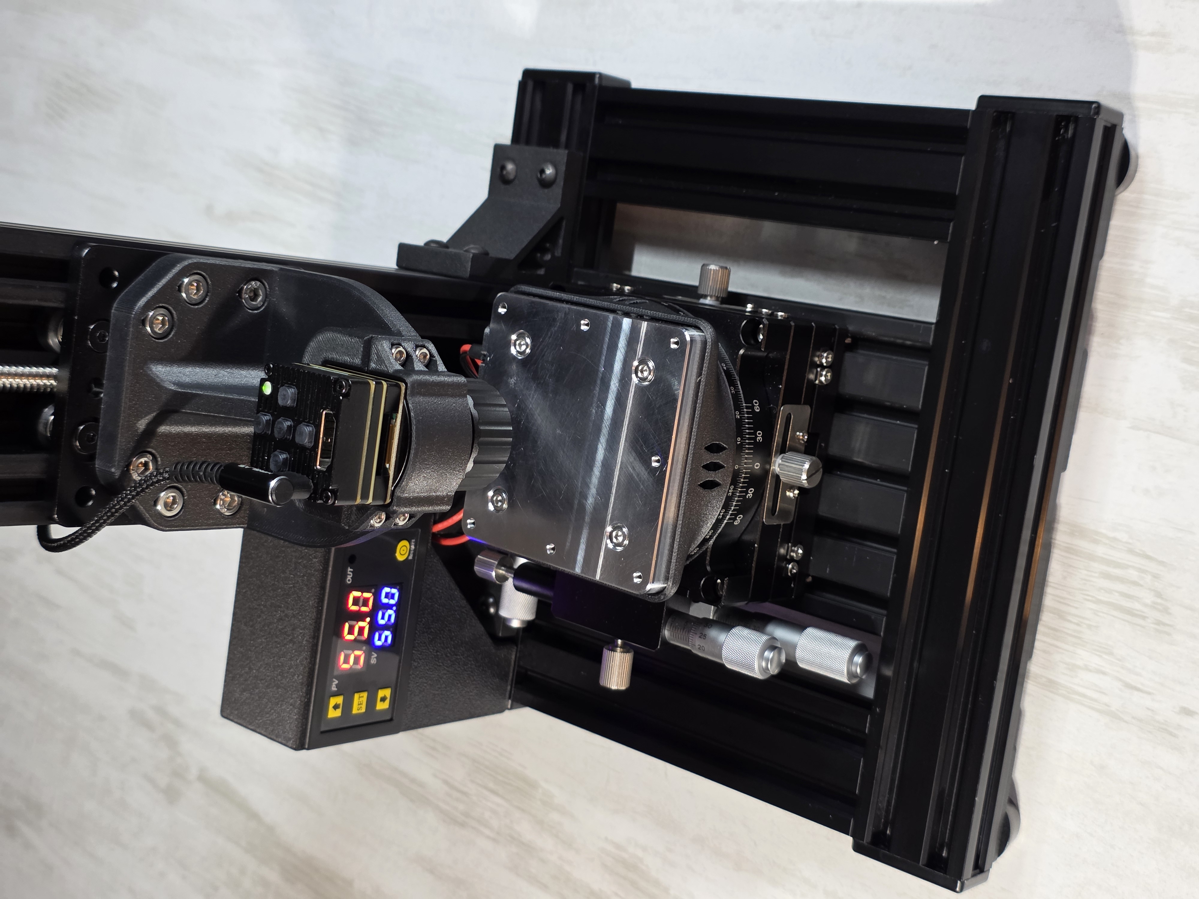 Close-up of thermal camera head on precision XY rail with rotation stage and angle markings